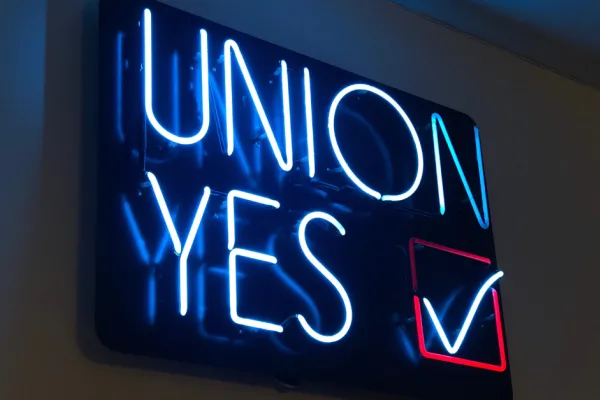 "UNION YES" neon sign lit up in the dark