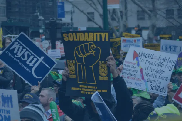 Signs at a labor rally with blue overlay