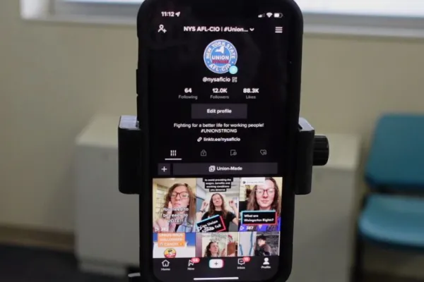 Photo of an iPhone on a tripod with a TikTok profile on screen