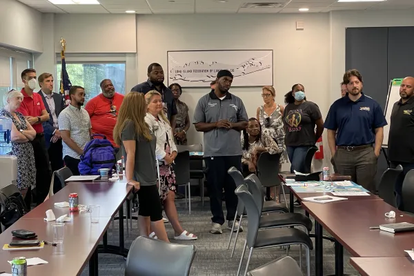 people standing up participating in training