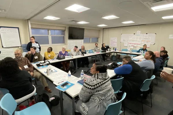 people at tables participating in training