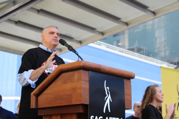 Mario Cilento speaking at a podium at a rally