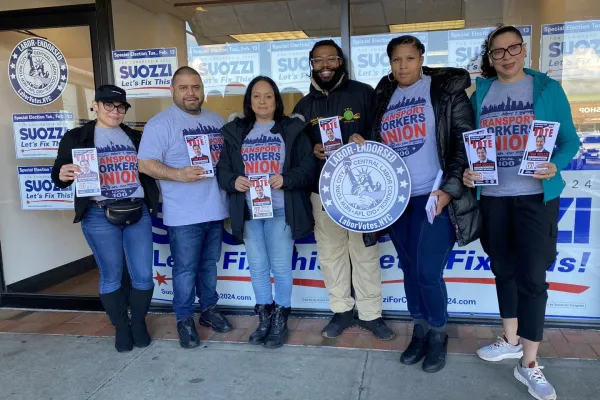 Union members with Tom Suozzi palm cards and signs