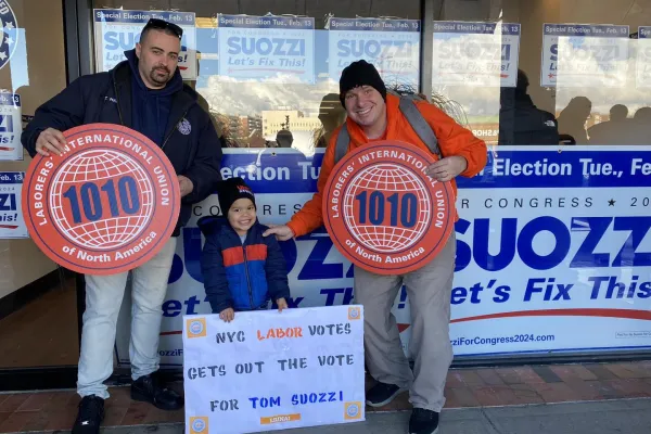 Union members and a child with signs