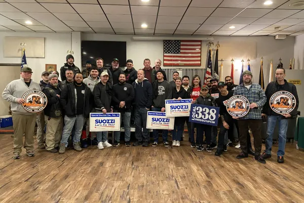 Union members posing together with signs before walking for Tom Suozzi