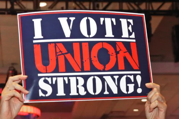 hands holding sign that says "i vote union strong"