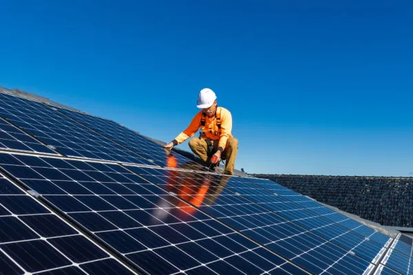 worker installing solar panels
