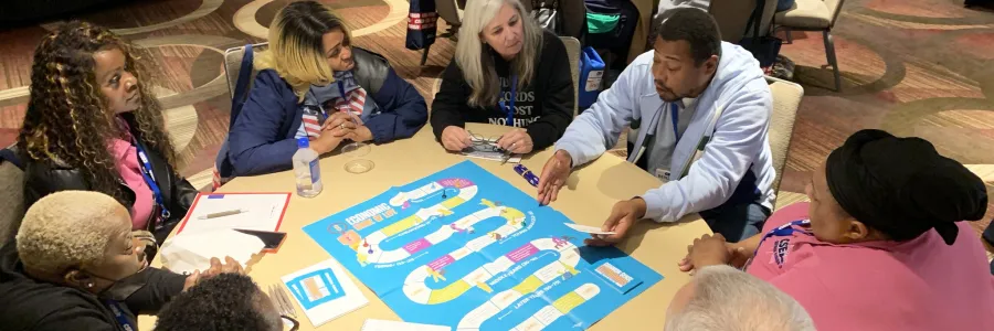 Two round tables of individuals participating in training