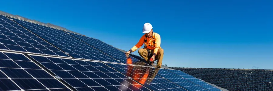 worker installing solar panels