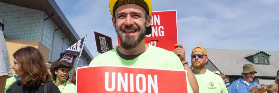 worker holding union strong sign at labor day event