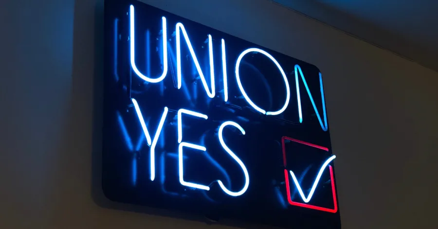 "UNION YES" neon sign lit up in the dark