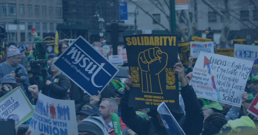 Signs at a labor rally with blue overlay