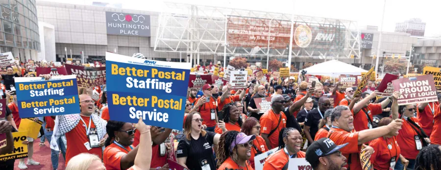 APWU members at a rally with signs advocating for better staffing and a fair contract