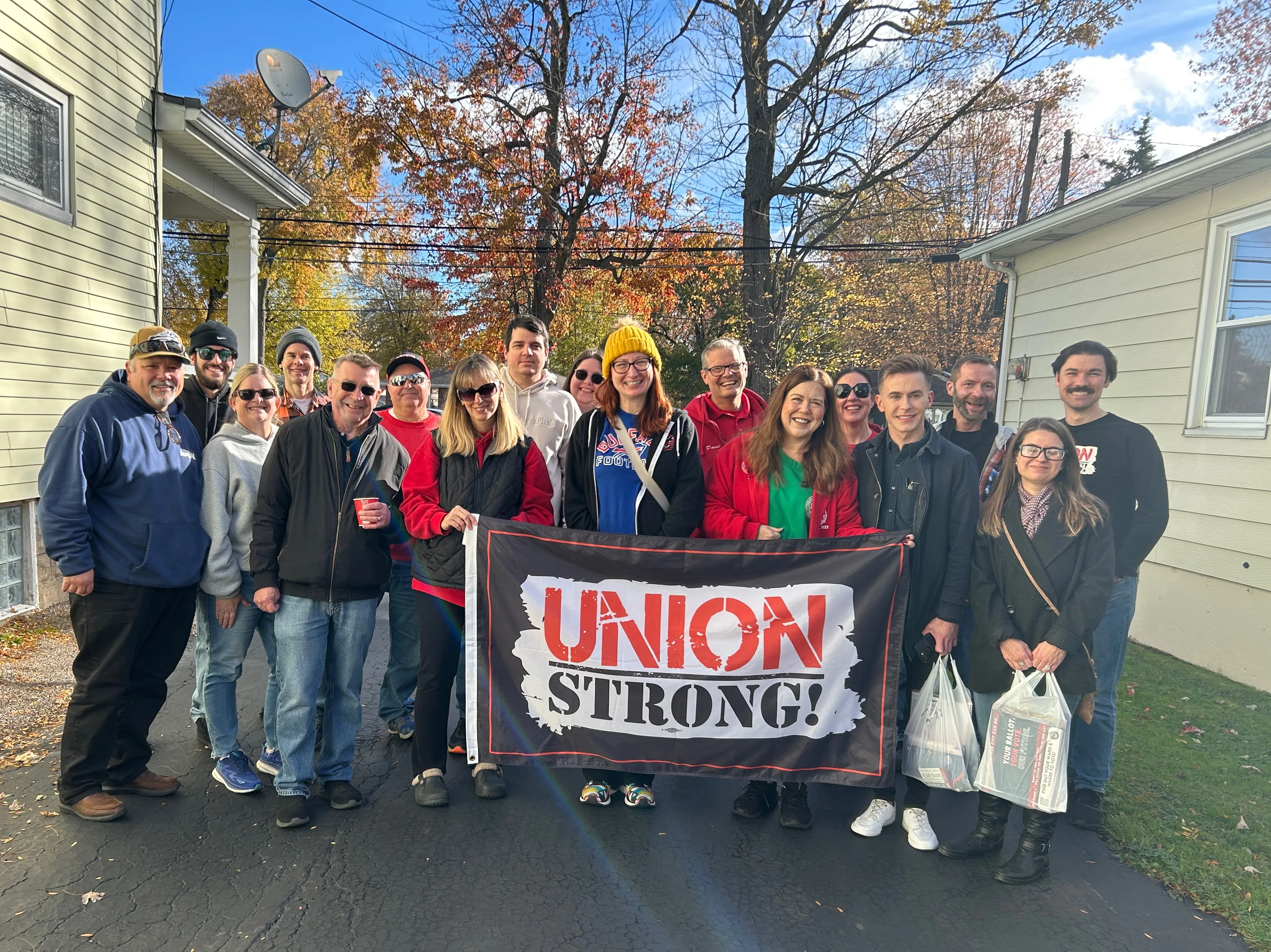 group of volunteers holding union strong flag